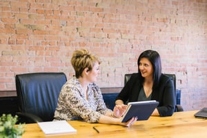 two women talking in an office